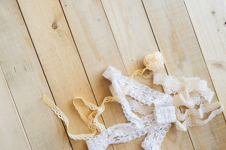 lace ribbon on wooden background, crafts conceptの写真素材