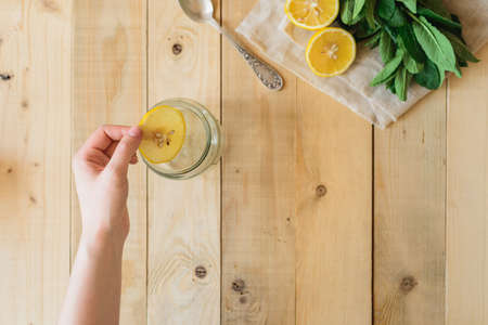 ingredients for homemade lemonade in a wooden interiorの写真素材