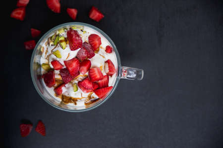 top view icecream in a mug with a fresh strawberry harvestの写真素材