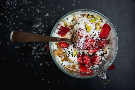 icecream in a cup with strawberry, pistachio, coconutの写真素材