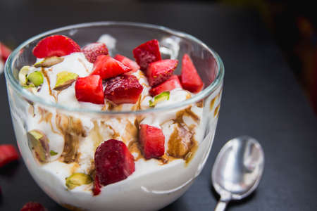 icecream in a mug with a fresh strawberry harvestの写真素材