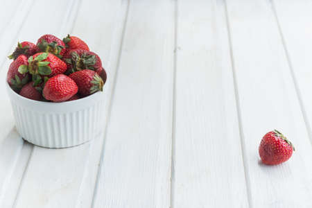strawberries in bowl on white background with copyspaceの写真素材