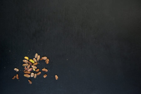 pile of pistachios on a black slate surface