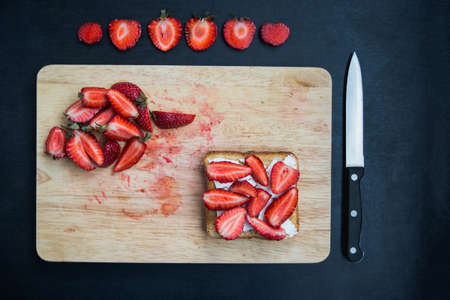 crispy toast with feta cheese and fresh strawberry harvestの写真素材