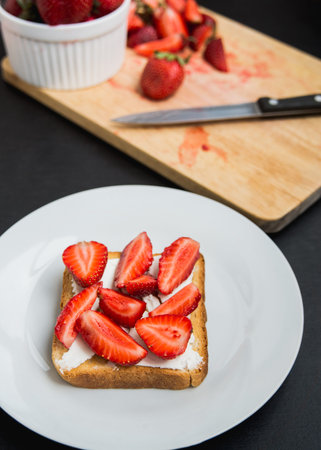 toast with feta cheese and freshly gathered strawberriesの写真素材