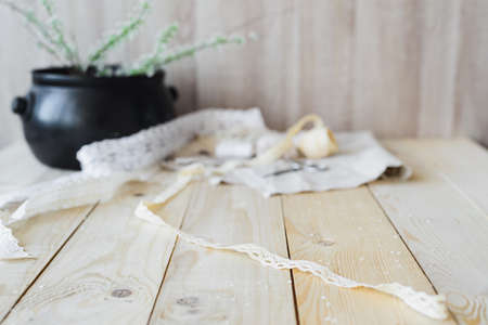 crafts concept, lace ribbon and flowering branch on wooden table,  soft focusの写真素材