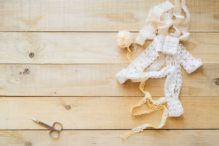 crafts concept, lace ribbon on wooden backgroundの写真素材