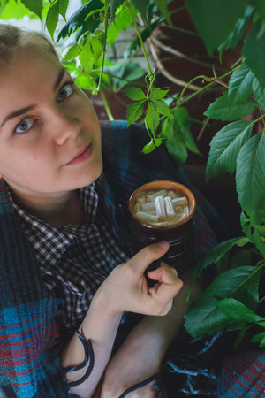 caucasian young woman drinking cocoa with marshmallow