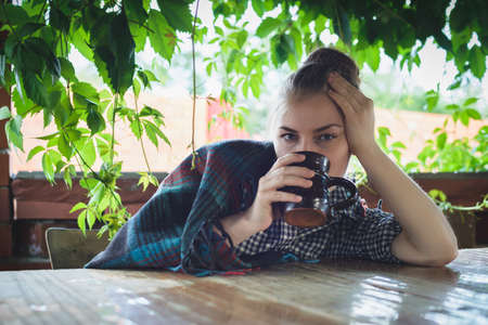 caucasian young woman drinking cocoa with marshmallowの写真素材