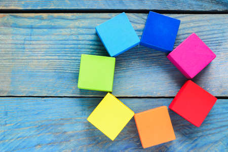 Rainbow of wooden blocks on blue backgroundの写真素材