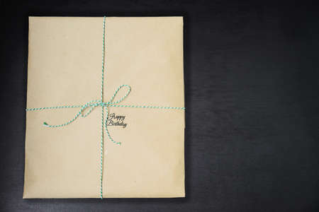 Happy birthday inscription on wrapped in kraft paper giftsの写真素材