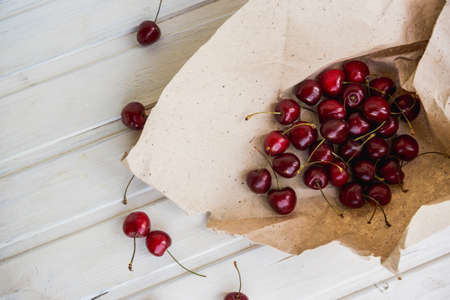 cherries in kraft and near on white backgroundの写真素材