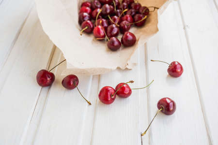 cherries in kraft and near on white backgroundの写真素材