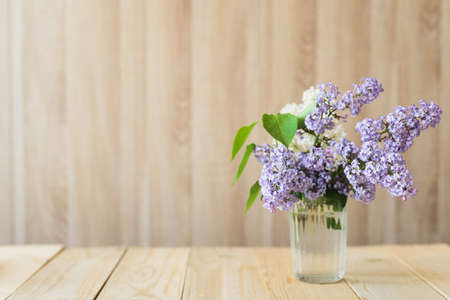 lilac in glass jar on wooden backgroundの写真素材