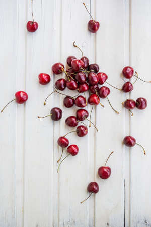 bunch of cherries on white wooden backgroundの写真素材