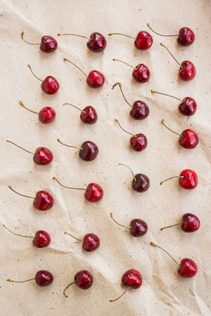 cherries in a row on kraft paper backgroundの写真素材