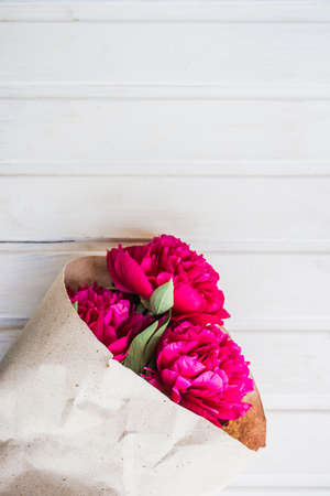 bouquet of peonies on white wooden backgroundの写真素材