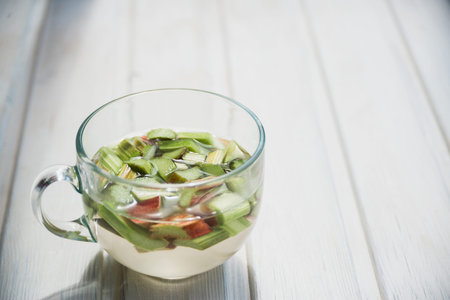 beverage of rhubarb on a white wooden deckの写真素材