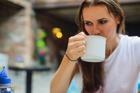 portrait of the brunette girl in outdoor cafe