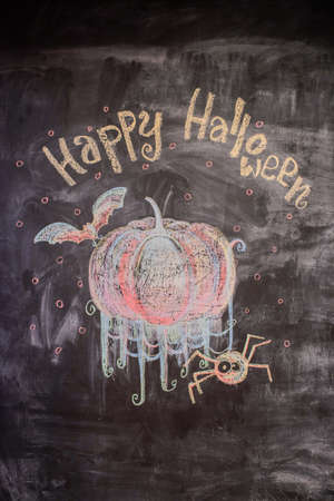 Chalk pattern of happy halloween on slateの写真素材