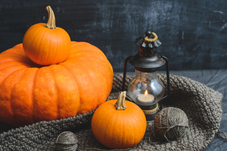 composition of three pumpkins, candles and knittingの写真素材