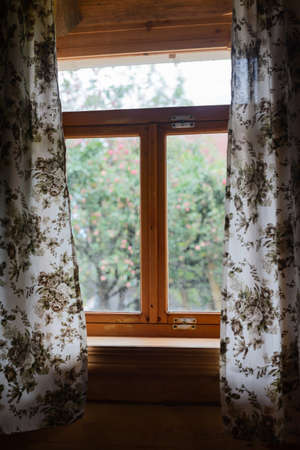 rustic wooden window overlooking the apple orchardの写真素材
