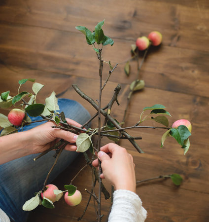Florist makes basis for bouquet of apple branches