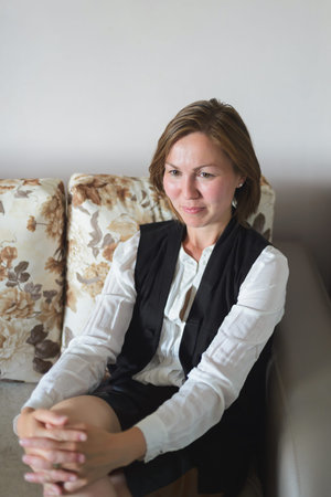 Portrait of a young woman sitting on the couch