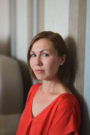 Portrait of young woman sitting on floorの写真素材
