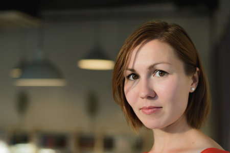 portrait of young woman at cafe near windowの写真素材