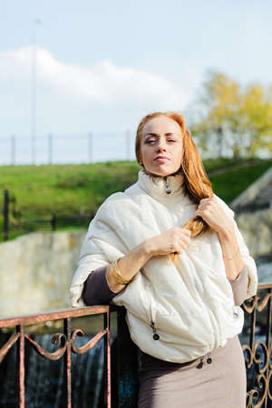haired young woman posing in the autumn parkの写真素材
