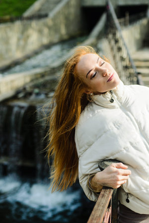 haired young woman posing in the autumn park