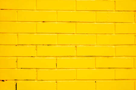 painted yellow brick wall as a backgroundの写真素材