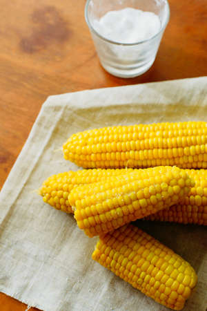just cooked corn with salt on table, rustic conceptの写真素材