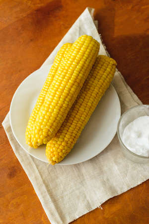 just cooked corn with salt on table, rustic conceptの写真素材