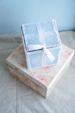 festive gift box with lace and satin ribbon on the birth of baby boyの写真素材
