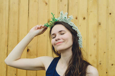 flowers branches spirea on a head of young womanの写真素材