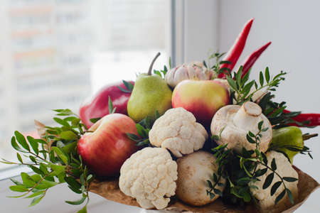 autumn bouquet of fresh fruits, vegetables and mushrooms as concept of accumulate vitamins for the winterの写真素材