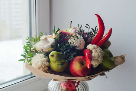 autumn bouquet of fresh fruits, vegetables and mushrooms as concept of accumulate vitamins for the winterの写真素材