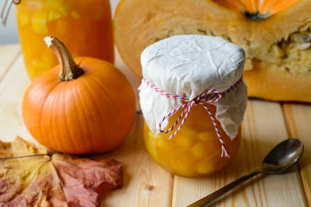 Autumn still life of homemade pumpkin jam on natural wood tableの写真素材