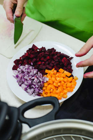 white caucasian woman preparing a vegetarian dinnerの写真素材