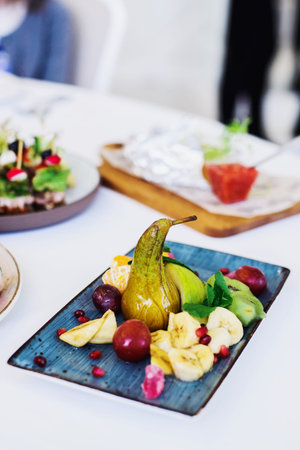 fruit plate with honey on festive table, stock photo image