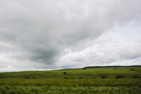 bad weather in summer, dramatic rainy sky clouds over agricultural rural landscape, stock photo...
