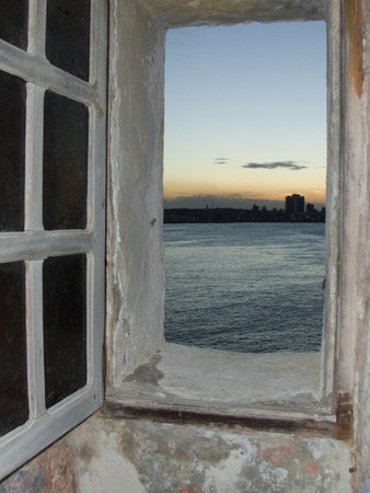 View of sunset in Havana, through a window of the Morro Castle