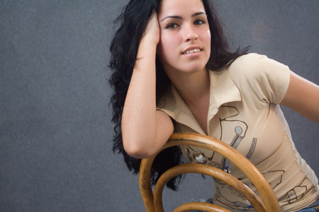 Young girl sitting in an old chair