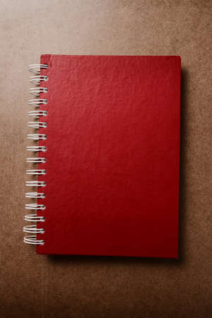 Red notebook on wood textureの写真素材