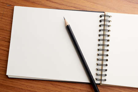 Writing on Notebook With Pencilの写真素材