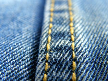 blue jeans stitched yellow thread, close upの写真素材