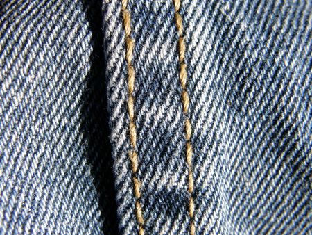 blue jeans stitched yellow thread, close upの写真素材