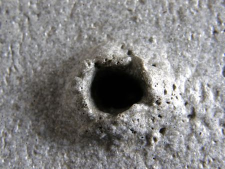 hole in the concrete from the bubbleの写真素材